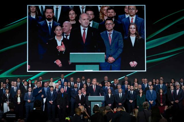 Former Bulgaria's president Rumen Radev (C) appears on a screen as he speaks to supporters during the final pre-election event of his political coalition "Progressive Bulgaria" in Sofia on April 16, 2026. Bulgaria will hold its eighth general election in five years on April 19, 2026, with ex-president Rumen Radev's new grouping tipped to win a ballot many hope will end chronic instability. (Photo by Nikolay DOYCHINOV / AFP)