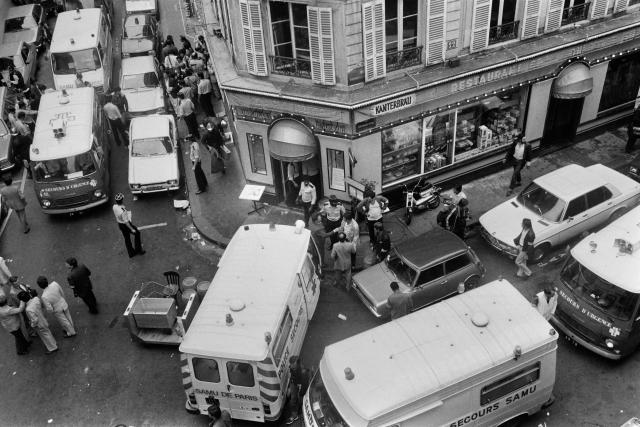 (FILES) View of firemen and a rescuers in the rue des Rosiers after the French-Jewish delicatessen restaurant Jo Goldenberg was attacked on August 9, 1982 in Paris by gunmen that threw a grenade into the restaurant and shot at customers with sub-machine guns, killing six customers and injuring 22 others. The Palestinian Authority extradited suspect Hicham Harb to France on April 16, 2026 who is wanted over an attack against a Jewish restaurant in Paris in 1982, his lawyer told AFP. Harb is one of four suspects sought in connection with the attack on the Jo Goldenberg restaurant in the Marais, a Jewish neighbourhood in Paris on August 9, 1982. (Photo by Jacques DEMARTHON / AFP)