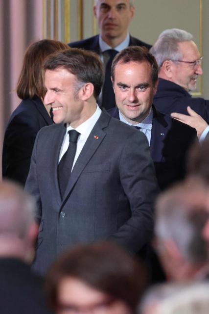 France's Prime Minister Sebastien Lecornu (R) and France's President Emmanuel Macron (C) attend a reception organized for 500 mayors from across the political spectrum and from every part of the country, to 'support' and 'mobilize' these 'alveoli of the nation's democratic lungs', one month after France's municipal elections at the presidential Elysee Palace in Paris on April 16, 2026. (Photo by Ludovic MARIN / POOL / AFP)
