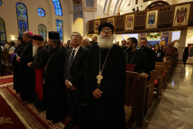 Clergy and Christian worshippers attend a service at the Coptic Orthodox Patriarchate Church during a mass for "World Peace", where all Christian denominations gathered to pray for an end to the war in the Middle East, in Baghdad on April 16, 2026.  (Photo by AHMAD AL-RUBAYE / AFP)