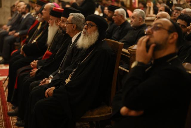 Clergy and Christian worshippers attend a service at the Coptic Orthodox Patriarchate Church during a mass for "World Peace", where all Christian denominations gathered to pray for an end to the war in the Middle East, in Baghdad on April 16, 2026.  (Photo by AHMAD AL-RUBAYE / AFP)