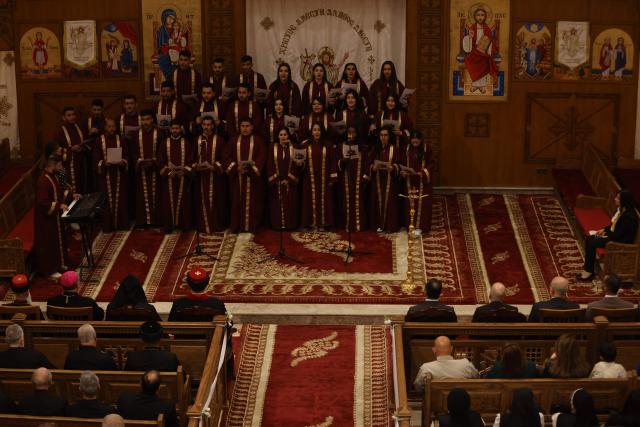 The choir sings as Christians attend a service at the Coptic Orthodox Patriarchate Church during a mass for "World Peace", where all Christian denominations gathered to pray for an end to the war in the Middle East, in Baghdad on April 16, 2026.  (Photo by AHMAD AL-RUBAYE / AFP)