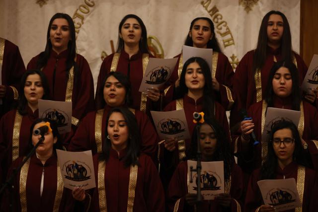 The choir sings as Christians attend a service at the Coptic Orthodox Patriarchate Church during a mass for "World Peace", where all Christian denominations gathered to pray for an end to the war in the Middle East, in Baghdad on April 16, 2026.  (Photo by AHMAD AL-RUBAYE / AFP)