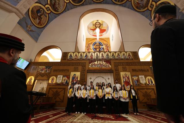 The choir sings as Christians attend a service at the Coptic Orthodox Patriarchate Church during a mass for "World Peace", where all Christian denominations gathered to pray for an end to the war in the Middle East, in Baghdad on April 16, 2026.  (Photo by AHMAD AL-RUBAYE / AFP)