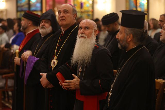 Clergy and Christian worshippers attend a service at the Coptic Orthodox Patriarchate Church during a mass for "World Peace", where all Christian denominations gathered to pray for an end to the war in the Middle East, in Baghdad on April 16, 2026.  (Photo by AHMAD AL-RUBAYE / AFP)