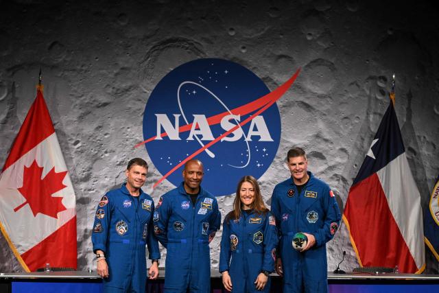 (L-R) NASA's Artemis II mission astronauts, commander Reid Wiseman, Victor Glover, Christina Koch and Canadian Space Agency's Jeremy Hansen pose for a photograph during a press conference at Johnson Space Center in Houston, Texas, on April 16, 2026. The four astronauts of Artemis II mission did the first slingshot around the Moon in more than 50 years and traveled deeper into space than any humans before, culminating in a smooth splashdown on April 10 off the coast of California. (Photo by RONALDO SCHEMIDT / AFP)