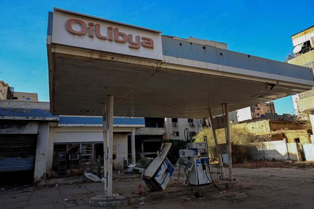 This photograph shows a general view of a destroyed gas station in the capital Khartoum on April 16, 2026. Of the nearly four million people -- around half Khartoum's pre-war population -- who fled during the conflict, more than 1.8 million have returned over the past year. Yet fewer than 80,000 people have come back to central Khartoum, according to the United Nations. (Photo by Khaled DESOUKI / AFP)