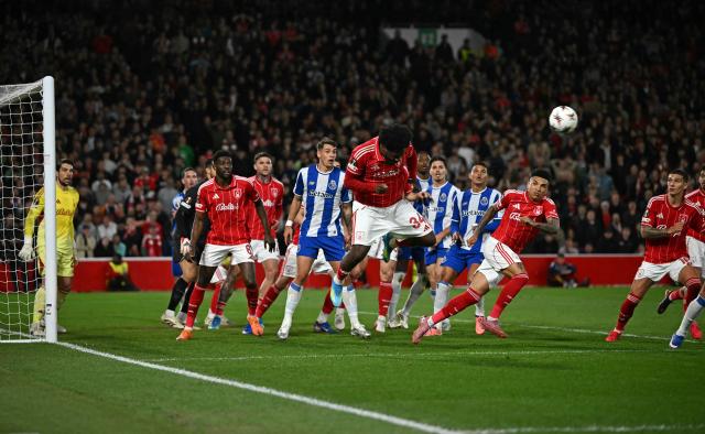 Nottingham Forest's Nigerian defender #34 Ola Aina headers the ball clear from a corner kick during the UEFA Europa League quarter final second-leg football match between Nottingham Forest and FC Porto at The City Ground in Nottingham, central England, on April 16, 2026. Forest won the match 1-0. (Photo by Paul ELLIS / AFP)