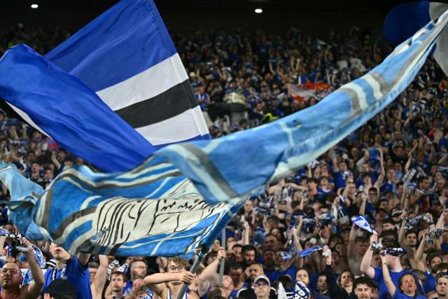 Strasbourg's supporters celebrate their team's victory in the stands at the end of the UEFA Europa Conference League quarter-final second leg football match between RC Strasbourg Alsace and Mainz 05 at the Stade de La Meinau in Strasbourg, eastern France, on April 16, 2026. (Photo by SEBASTIEN BOZON / AFP)