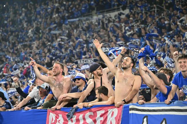 Strasbourg's supporters celebrate their team's victory in the stands at the end of the UEFA Europa Conference League quarter-final second leg football match between RC Strasbourg Alsace and Mainz 05 at the Stade de La Meinau in Strasbourg, eastern France, on April 16, 2026. (Photo by SEBASTIEN BOZON / AFP)