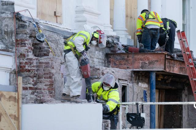 (FILES) Construction workers demolish what is remaining of the East Wing of the White House alongside the main Residence as demolition continues in preparation to build a new ballroom for the White House in Washington, DC, December 1, 2025. A US federal judge on April 16, 2026 extended an order barring construction of President Donald Trump's White House ballroom but gave the green light for work to proceed on a proposed underground bunker. (Photo by SAUL LOEB / AFP)
