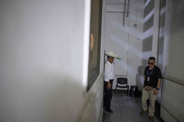 Peru's presidential candidate for the Juntos por el Peru party, Roberto Sanchez (C), arrives to deliver a press conference at his campaign office in Lima on April 16, 2026. On April 16, Peru's right-wing presidential hopeful Rafael Lopez Aliaga offered a $5,800 reward to any election official who produced proof of his claim that the April 12 election was fraudulent. (Photo by Ernesto BENAVIDES / AFP)
