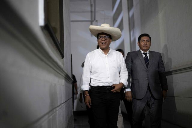 Peru's presidential candidate for the Juntos por el Peru party, Roberto Sanchez (L), arrives to deliver a press conference at his campaign office in Lima on April 16, 2026. On April 16, Peru's right-wing presidential hopeful Rafael Lopez Aliaga offered a $5,800 reward to any election official who produced proof of his claim that the April 12 election was fraudulent. (Photo by Ernesto BENAVIDES / AFP)