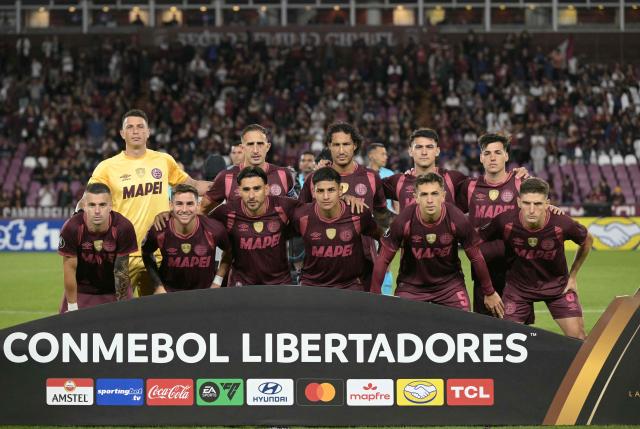 Players of Lanus pose for a picture ahead of the Copa Libertadores group stage football match between Argentina's Lanus and Bolivia's Always Ready at the Ciudad de Lanus stadium in Lanus, Buenos Aires province, Argentina, on April 16, 2026. (Photo by JUAN MABROMATA / AFP)