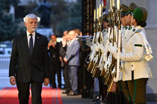 Czech Republic's President Petr Pavel reviews a guard of honour during the welcome ceremony at La Moneda Presidential Palace in Santiago on April 16, 2026. (Photo by RODRIGO ARANGUA / AFP)