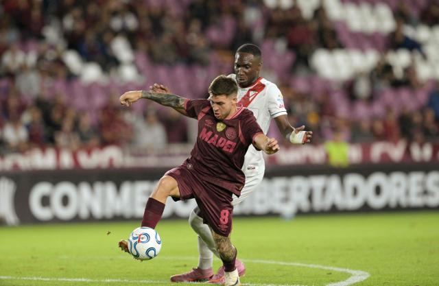 Lanus' midfielder #08 Franco Watson and Always Ready's Ecuadorian defender #3 Luis Caicedo fight for the ball during the Copa Libertadores group stage football match between Argentina's Lanus and Bolivia's Always Ready at the Ciudad de Lanus stadium in Lanus, Buenos Aires province, Argentina, on April 16, 2026. (Photo by JUAN MABROMATA / AFP)