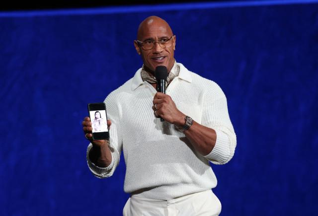 US actor/producer Dwayne Johnson holds a photo of his grandfather Peter Maivia as he promotes the upcoming live action "Moana" during the Walt Disney Studios presentation at CinemaCon at The Colosseum at Caesars Palace on April 16, 2026 in Las Vegas, Nevada. (Photo by VALERIE MACON / AFP)
