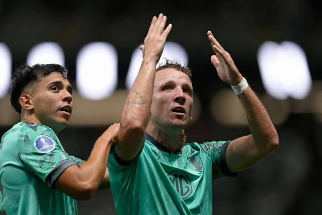Juventud's midfielder #21 Facundo Perez (R) celebrates with teammate forward #15 Alejo Cruz after scoring his team's first goal during the Copa Sudamericana group stage football match between Brazil's Atletico Mineiro and Uruguay's Juventud at the Arena MRV stadium in Belo Horizonte, state of Minas Gerais, Brazil, on April 16, 2026. (Photo by DOUGLAS MAGNO / AFP)
