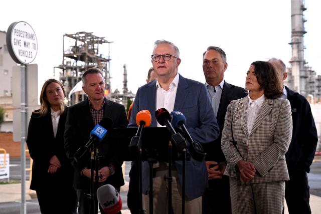Australia's Prime Minister Anthony Albanese (C) speaks during a press conference after a visit to the Geelong Oil Refinery in Geelong on April 17, 2026. The visit comes a day after a fire ripped through the oil refinery but Australia's deputy Prime Minister Richard Marles said it would have a minimal impact on fuel supply. (Photo by William WEST / AFP)