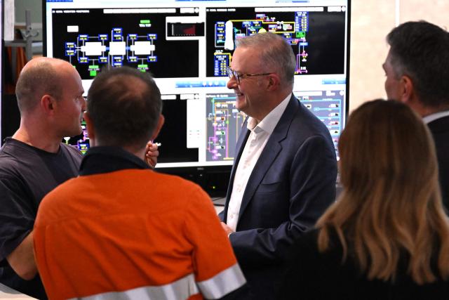 Australia's Prime Minister Anthony Albanese (C) speaks to Viva Energy staff in the control room of the Geelong Oil Refinery in Geelong on April 17, 2026. The visit comes a day after a fire ripped through the oil refinery but Australia's deputy Prime Minister Richard Marles said it would have a minimal impact on fuel supply. (Photo by William WEST / AFP)