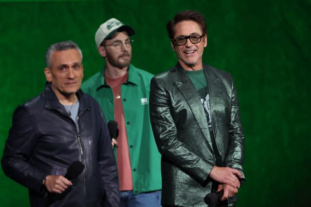 US actor Chris Evans (C), US actor Robert Downey Jr. (R) and US filmmaker Joe Russo (L) promote "Avengers: Doomsday" during the Walt Disney Studios presentation at CinemaCon at The Colosseum at Caesars Palace on April 16, 2026 in Las Vegas, Nevada. (Photo by VALERIE MACON / AFP)