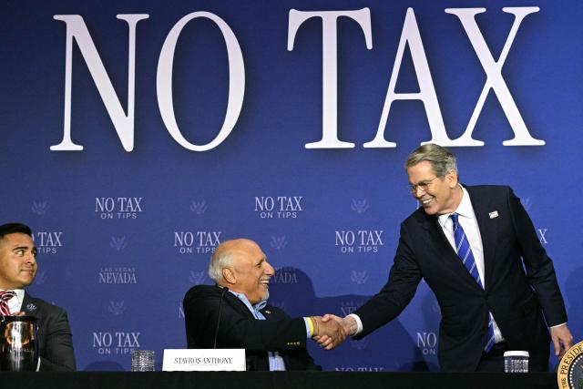 US Secretary of Treasury Scott Bessent (R) shakes hands with Nevada Lieutenant Governor Stavros Anthony during a roundtable discussion on the US president's "no tax on tips" policy at the AC Hotel Las Vegas Symphony Park in Las Vegas, Nevada, on April 16, 2026. (Photo by Jim WATSON / AFP)