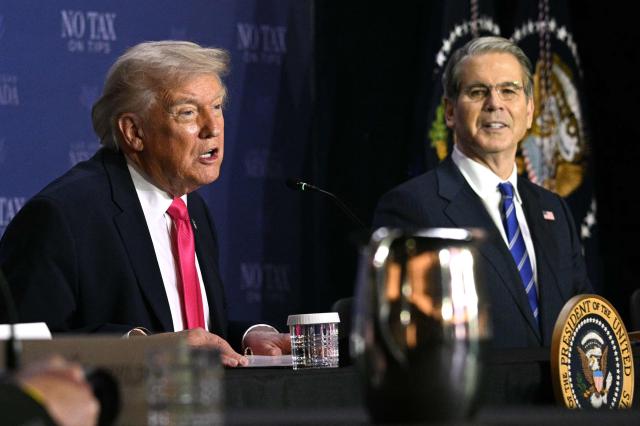 US President Donald Trump (L) speaks, flanked by US Secretary of Treasury Scott Bessent, during a roundtable discussion on his "no tax on tips" policy at the AC Hotel Las Vegas Symphony Park in Las Vegas, Nevada, on April 16, 2026. (Photo by Jim WATSON / AFP)