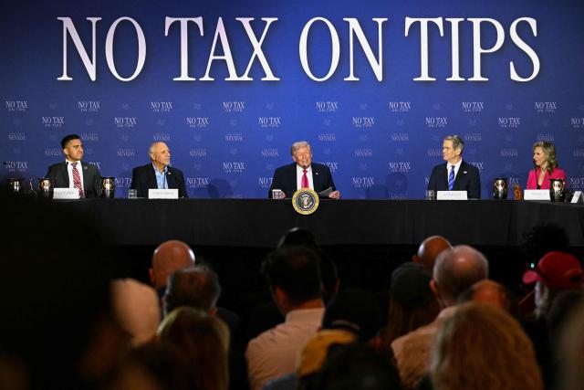 US President Donald Trump (C) speaks, flanked by US Secretary of Treasury Scott Bessent (2R) and Nevada Lieutenant Governor Stavros Anthony (2L), during a roundtable discussion on his "no tax on tips" policy at the AC Hotel Las Vegas Symphony Park in Las Vegas, Nevada, on April 16, 2026. (Photo by Jim WATSON / AFP)