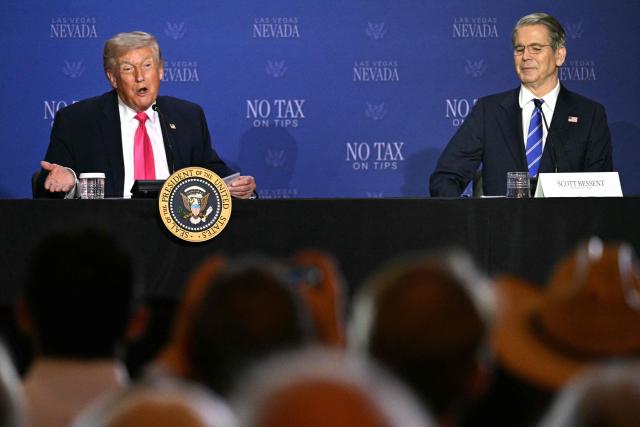 US President Donald Trump (L) speaks, flanked by US Secretary of Treasury Scott Bessent, during a roundtable discussion on his "no tax on tips" policy at the AC Hotel Las Vegas Symphony Park in Las Vegas, Nevada, on April 16, 2026. (Photo by Jim WATSON / AFP)