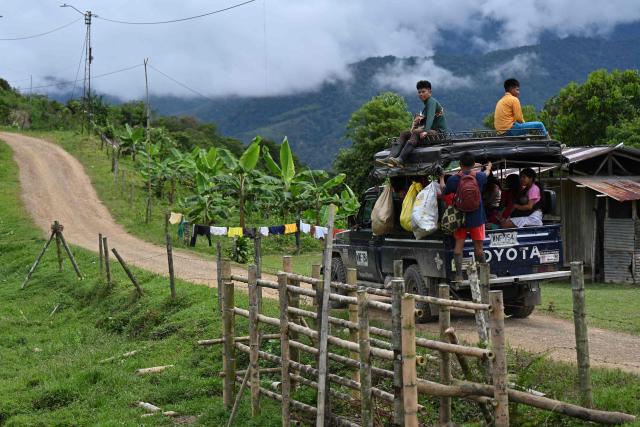 Embera Chami Indigenous people take transport to go down the mountain in Vereda Tuma Drua, in the unified Embera Chami Rio San Juan reservation, Pueblo Rico, Risaralda, Colombia, on April 9, 2026. In the coffee-growing mountains of the Risaralda department in western Colombia, ancestral territory of the Embera Chami and Katio peoples, genital mutilation affects hundreds of girls. (Photo by Diana SANCHEZ / AFP)