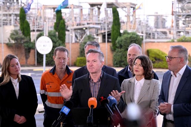Minister for Climate Change and Energy Chris Bowen (C) speaks at a press conference during a visit to the Geelong Oil Refinery in Geelong on April 17, 2026. The visit comes a day after a fire ripped through the oil refinery but Australia's deputy Prime Minister Richard Marles said it would have a minimal impact on fuel supply. (Photo by William WEST / AFP)