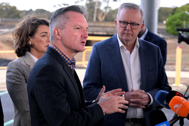 Minister for Climate Change and Energy Chris Bowen (C) speaks as Australia's Prime Minister Anthony Albanese (R) listens in a press conference during a visit to the Geelong Oil Refinery in Geelong on April 17, 2026. The visit comes a day after a fire ripped through the oil refinery but Australia's deputy Prime Minister Richard Marles said it would have a minimal impact on fuel supply. (Photo by William WEST / AFP)