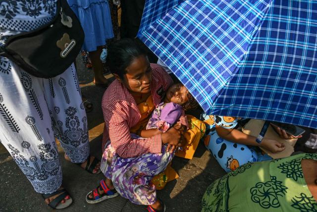Relatives wait for the release of prisoners from Insein prison to mark the Myanmar New Year in Yangon on April 17, 2026. (Photo by Sai Aung MAIN / AFP)
