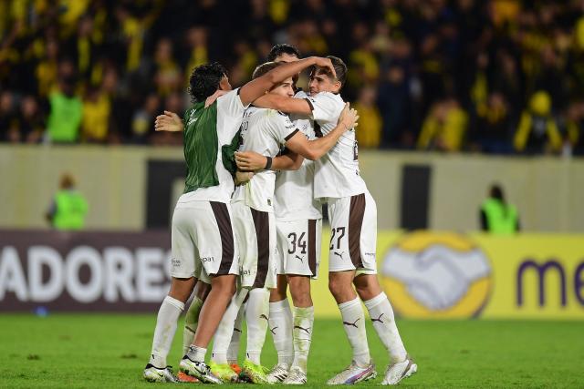 Platense players celebrate after winning the Copa Libertadores group stage football match between Uruguay's Penarol and Argentina's Platense at the Campeon del Siglo stadium in Montevideo on April 16, 2026. (Photo by Dante FERNANDEZ / AFP)