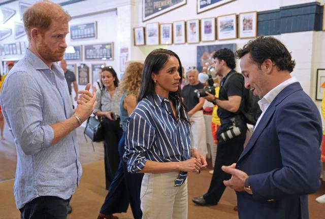 Britain's Prince Harry (L), Duke of Sussex, and his wife Meghan, the Duchess of Sussex, speak with Elon Zizerb (R), Bondi beach terror attack survivor, during a meeting with volunteer first responders from Bondi Surf Bathers' Life Saving Club in Sydney on April 17, 2026. (Photo by Jonathan Brady / POOL / AFP)