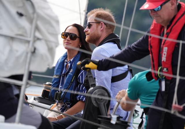 Britain's Prince Harry, Duke of Sussex, and his wife Meghan, the Duchess of Sussex, take part in a sailing event with members of Invictus Australia in Sydney Harbour on April 17, 2026. (Photo by Jonathan Brady / POOL / AFP)