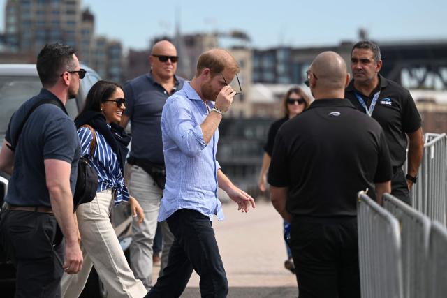 Britain’s Prince Harry, Duke of Sussex, and his wife Meghan, Duchess of Sussex, arrive to meet members of the public beneath the steps of Australia’s iconic Sydney Opera House on April 17, 2026. (Photo by Saeed KHAN / AFP)