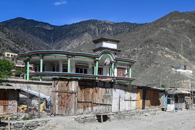 This photograph taken on April 13, 2026 shows closed shops at a market due to the conflict between Taliban security personnel and Pakistani forces near the Durand Line border between Pakistan and Afghanistan in the Barikot village of Naray district, Kunar province. There are no children in the Afghan border village of Barikot, where the school has been smashed by shells and the playground sits deserted after weeks of war with Pakistan. More than 94,000 Afghans have been displaced by the war, OCHA figures show, more than a quarter of them in Kunar province. (Photo by Wakil KOHSAR / AFP)