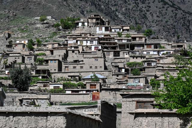 This photograph taken on April 13, 2026 shows uninhabited houses resulting from clashes between Taliban security personnel and Pakistani forces near the Durand Line in the Barikot village of Naray district, Kunar province. There are no children in the Afghan border village of Barikot, where the school has been smashed by shells and the playground sits deserted after weeks of war with Pakistan. More than 94,000 Afghans have been displaced by the war, OCHA figures show, more than a quarter of them in Kunar province. (Photo by Wakil KOHSAR / AFP)