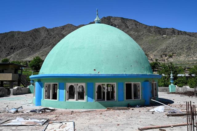 This photograph taken on April 13, 2026 shows the shattered dome windows of a mosque damaged by a Pakistani mortar shell during clashes between Taliban security personnel and Pakistani forces near the Durand Line in the Barikot village of Naray district, Kunar province. There are no children in the Afghan border village of Barikot, where the school has been smashed by shells and the playground sits deserted after weeks of war with Pakistan. More than 94,000 Afghans have been displaced by the war, OCHA figures show, more than a quarter of them in Kunar province. (Photo by Wakil KOHSAR / AFP)