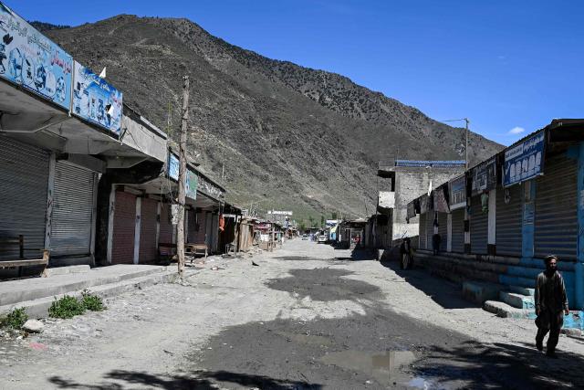 This photograph taken on April 13, 2026 shows closed shops due to the conflict between Taliban security personnel and Pakistani forces at a market near the Durand Line in the Barikot village of Naray district, Kunar province. There are no children in the Afghan border village of Barikot, where the school has been smashed by shells and the playground sits deserted after weeks of war with Pakistan. More than 94,000 Afghans have been displaced by the war, OCHA figures show, more than a quarter of them in Kunar province. (Photo by Wakil KOHSAR / AFP)
