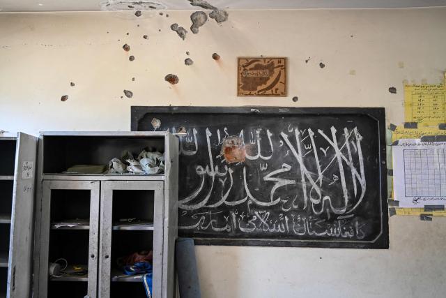 This photograph taken on April 13, 2026 shows a damaged school classroom after it was struck by a Pakistani mortar shell during clashes between Taliban security personnel and Pakistani forces near the Durand Line in the Barikot village of Naray district, Kunar province. There are no children in the Afghan border village of Barikot, where the school has been smashed by shells and the playground sits deserted after weeks of war with Pakistan. More than 94,000 Afghans have been displaced by the war, OCHA figures show, more than a quarter of them in Kunar province. (Photo by Wakil KOHSAR / AFP)