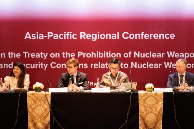 Celine Mahory (L), Director of Government Relations and Advocacy of the International Campaign to Abolish Nuclear Weapons (ICAN), and Michael Wislocki (2nd L), Charge d'Affaires of the Australian Embassy in Jakarta, attend a conference with representatives from more than 20 Asia-Pacific countries to discuss the universalisation and implementation of the Treaty on the Prohibition of Nuclear Weapons (TPNW) in Jakarta on April 17, 2026. (Photo by YASUYOSHI CHIBA / AFP)