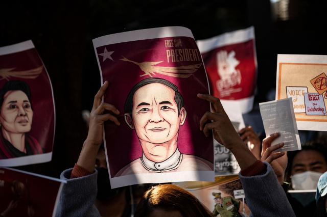 (FILES) Myanmar activists hold an image of their country's civilian president Win Myint as they protest outside the Myanmar embassy in Tokyo on February 7, 2021, after the country's military on February 1 seized power in a bloodless coup and detained its civilian leader Aung San Suu Kyi. Myanmar's ex-president Win Myint, detained since a 2021 military coup, was on April 17, 2026 pardoned of convictions by the junta that ousted his government. "The President has pardoned Win Myint," said a statement from the office of Min Aung Hlaing, who led the coup as military chief but was last week sworn in as civilian president. (Photo by Philip FONG / AFP)