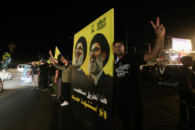 TOPSHOT - Hezbollah supporters celebrate a ceasefire with Israel in Sidon early on April 17, 2026. A 10-day ceasefire deal struck between Lebanon and Israel took effect on April 17, sending displaced residents streaming south towards their homes, even as the Lebanese army warned of "a number of violations" in the area. (Photo by MAHMOUD ZAYYAT / AFP)