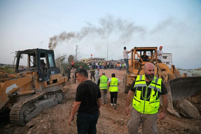 Excavators work to restore the site of Israeli strikes that targeted the Qasmieh bridge built over the Litani river in the southern Lebanese area of Al Qasmiyeh on April 17, 2026, for the displaced residents to travel back to their homes. A 10-day ceasefire deal struck between Lebanon and Israel took effect on April 17, sending displaced residents streaming south towards their homes, even as the Lebanese army warned of "a number of violations" in the area. (Photo by ibrahim AMRO / AFP)