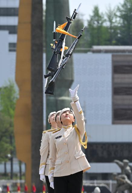 South Korean military honour guards perform during a public event to show their acrobatic performance at the War Memorial of Korea in Seoul on April 17, 2026. (Photo by Jung Yeon-je / AFP)