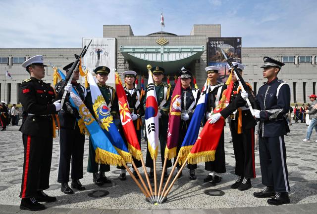 South Korean military honour guards pose for a photo after a public event to show their acrobatic performance at the War Memorial of Korea in Seoul on April 17, 2026. (Photo by Jung Yeon-je / AFP)