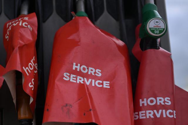 Out of service fuel pumps are pictured at a gas station blocked by Argedis employees to demand fuel assistance in Saint-Aubin-de-Terregatte, western France on April 17, 2026. The CGT union at Argedis, a TotalEnergies subsidiary that operates around 200 service stations, notably on motorways, has called on employees to strike on April 17, 2026 to demand financial assistance with fuel costs, amid soaring prices, the union said on April 16. (Photo by Damien MEYER / AFP)