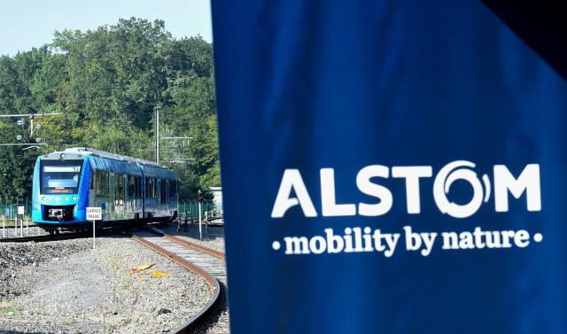 (FILES) This photograph taken on September 6, 2021 shows Alstom's logo and Alstom's Coradia iLint train, the first in the world to be powered by hydrogen, during its inauguration on the tracks of the Railway Test Center in Petite-Foret, northern France. Alstom’s share price plunged nearly 30% on April 17, 2026 less than half an hour after the opening of a session on the Paris Stock Exchange, following a downward revision of its financial performance targets due to delivery delays. (Photo by FRANCOIS LO PRESTI / AFP)